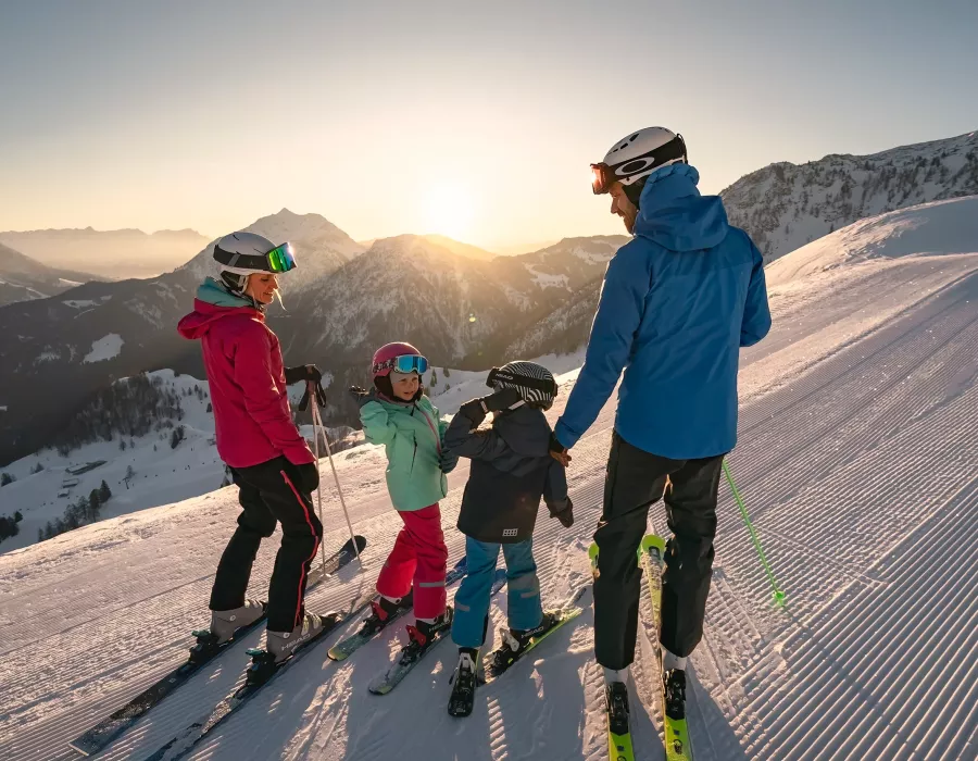 Familie beim Skifahren auf der Skipiste